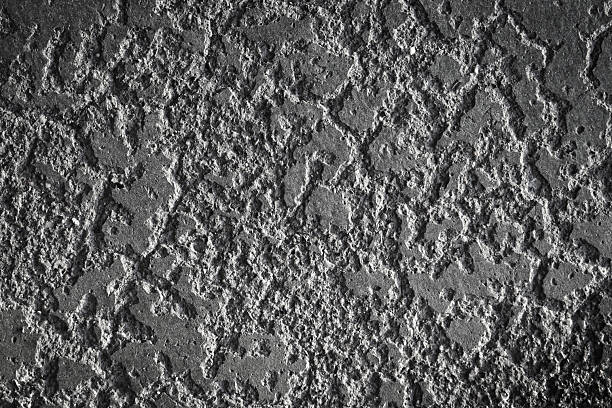 Detailed Closeup of Concrete Texture with Stong Side Light Revealing Texture of Worn Old Cement