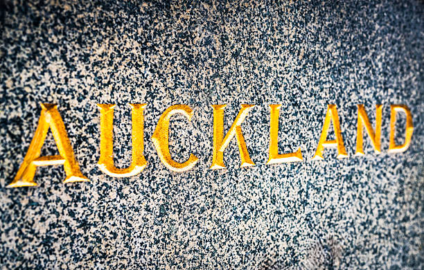 Close up of the word Auckland, carved in a marble exterior, and finished in gold leaf.