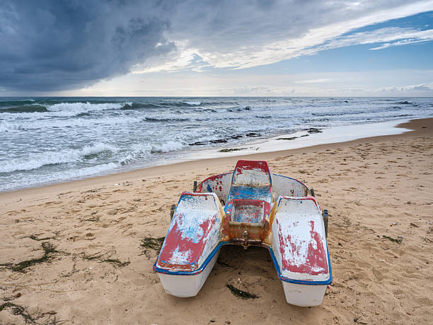 Malvarrosa Valencia Spain, Malvarrosa Valencia Spain wrecked wooden boat. boat stranded in the sand of a beach Broken abandoned boat in sand, sea coast line
