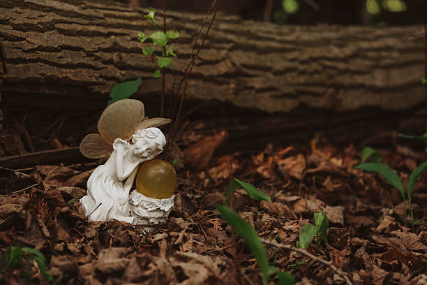 A ceramic fairy sleeping in the woods. Shot with a Canon 5D Mark IV.