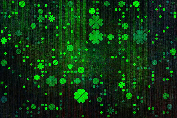 This vibrant and artistic abstract background features a variety of glowing green shamrocks floating over a dark, weathered texture, making it an ideal design element for celebratory Saint Patrick's Day projects and festive Irish themed seasonal digital graphic displays.