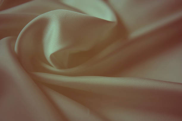 Elegant ivory white silk fabric with soft ripples and subtle greenish tint
