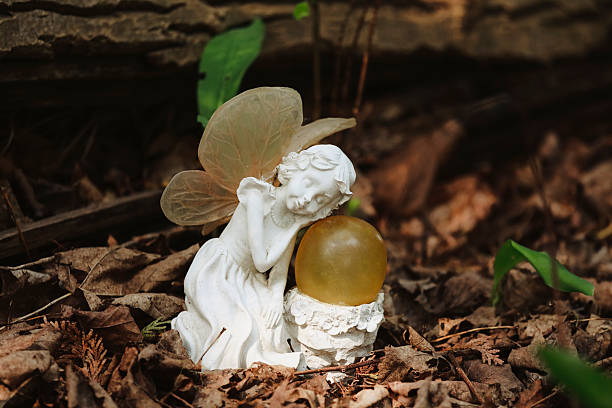 A ceramic fairy sleeping in the woods. Shot with a Canon 5D Mark IV.