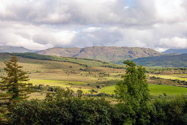 A cloudy day with a mountain in the background. The sky is overcast and the mountains are in the distance