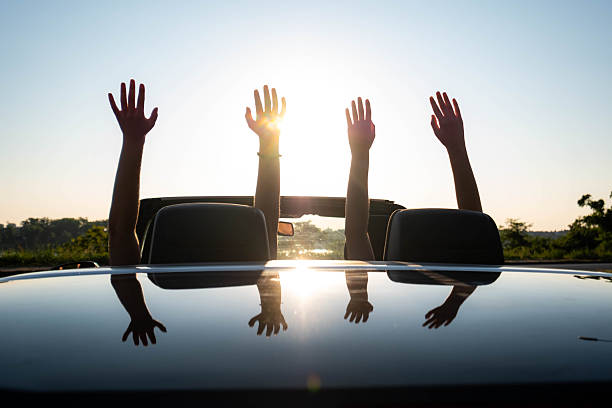 istock People raising hands enjoying summer car road trip 2262173189
