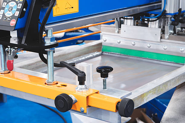 Industrial worker wearing safety gear and inspecting machinery components in a factory setting, ensuring equipment functionality and safety.