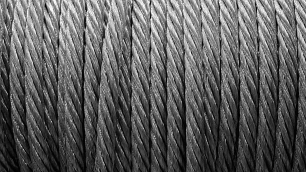 A closeup shot of rope on a wooden surface in black and white