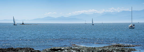 Sailing in a stiff breeze off Cattle Point near Victoria. British Columbia, Canada.