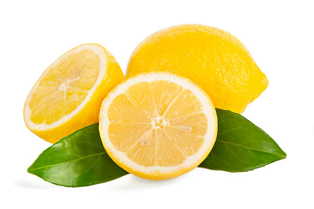 Whole lemon and a half with leaves on white background