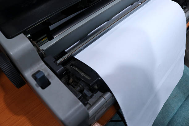 Photo of a printer on an office desk printing work results