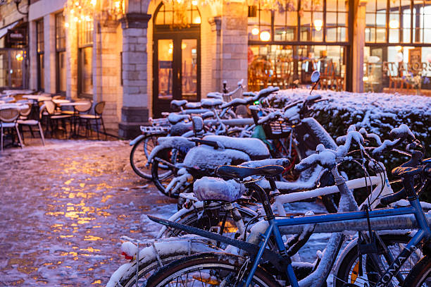 Outdoor view of many bycicles parked in the snow in the sreets of Ghent, Belgium