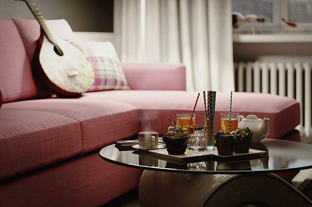 Tea and Muffins on Glass Coffee Table in Cozy Pink Sofa Living Room