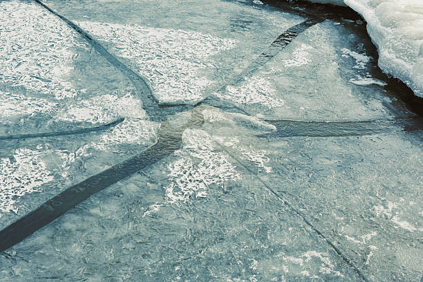 A sparkling ice surface is illuminated by the fading sunlight, showcasing intricate patterns under winter's charm.