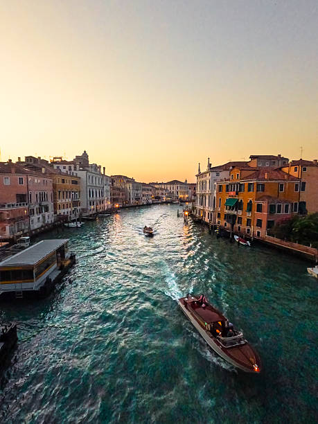 Venice Veneto, italy - 6 february 2016: Carnival Venice. Sunset view of the Grand Canal in Venice, Veneto, Italy. The sky displays a blend of pink, orange, and blue hues.