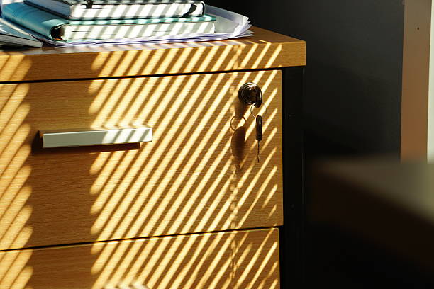 This image beautifully showcases a sleek and shiny metallic drawer handle designed for contemporary furnishings