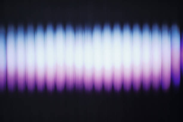 Luminous purple and blue blurry light stripes creating an abstract background.