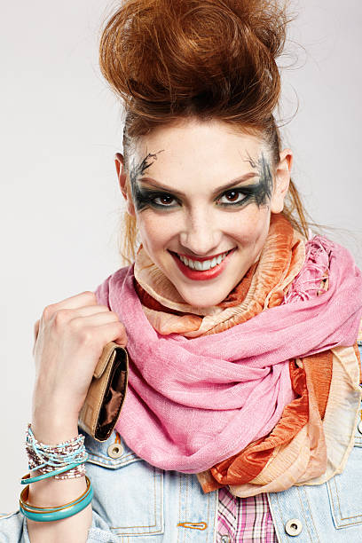 portrait of glam punk redhead young  woman posing on gray