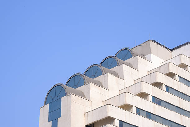 Modern Building with Arched Windows Against Clear Blue Sky