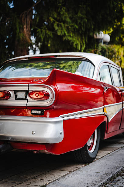 Los Angeles, CA, USA – August 21, 2022: Detail shot of red Impala rear quarter panel displaying triple circle tail lights and impala logo that was parked outdoors  in southern California