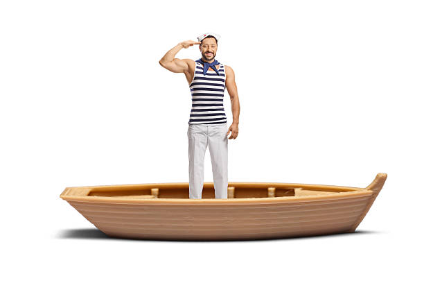Sailor saluting while standing in a small boat isolated on white background
