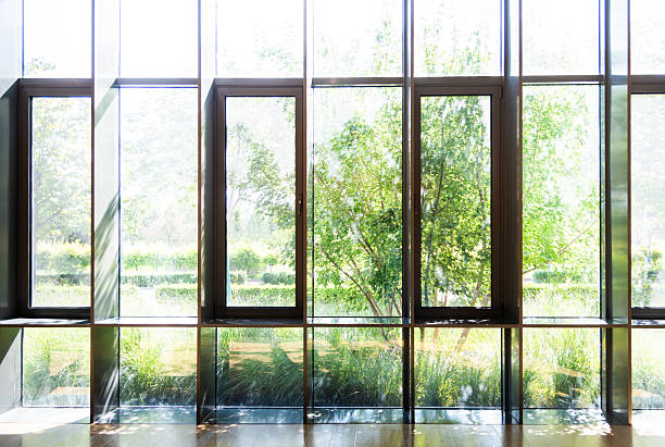 The bright rays of the sun illuminate the room through the old window of house in the morning
