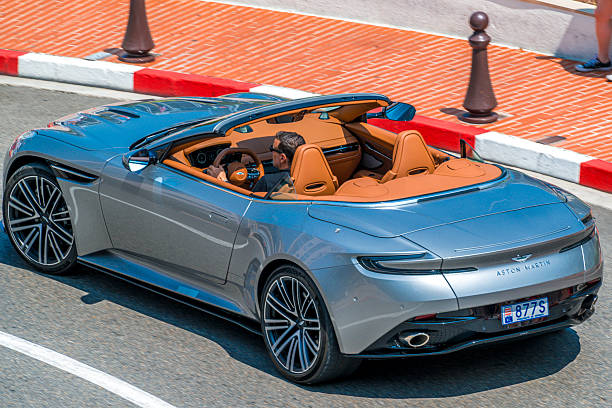 Aston Martin DB12 Volante driving on the street of Monte Carlo in the Grand Hotel Hairpin of the Monaco race track.