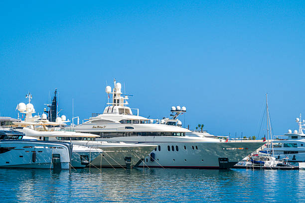 View on the Monaco harbour in in La Condamine and Monte Carlo from above during a beautiful summer day. Various yachts and superyachts are moored in the port of the city on the French Côte d'Azur.