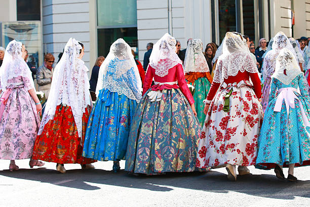 Valencia, Spain - March 18 2019: Colourful dresses in the Virgin Mary Parade to the town centre. The Valencia Las Fallas declared Intangible Cultural Heritage of UNESCO since 2016