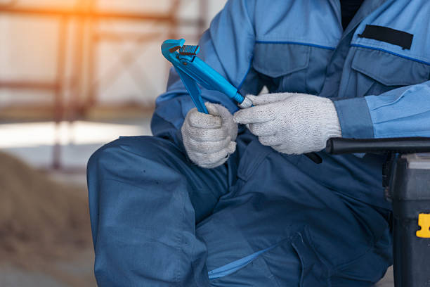 Construction engineer man hold blueprint wear blue shirt safety white hard hat at construction site industry labor worker. Architecture man engineer civil worker look at blueprint real estate concept