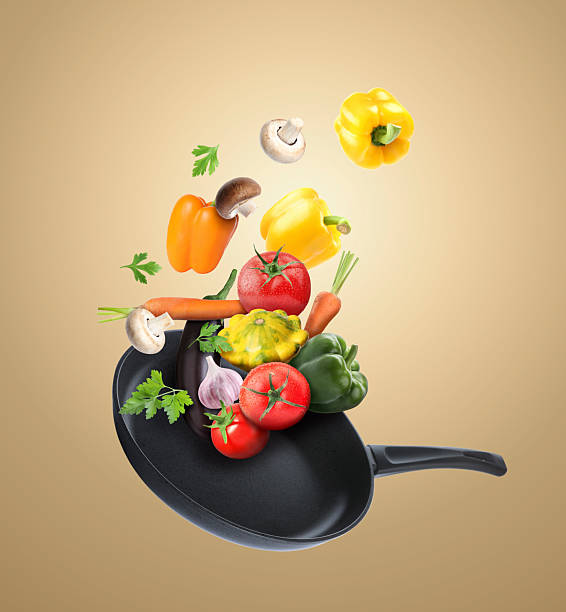 istock Frying pan and different vegetables in air on dark beige background 2262267763