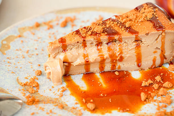 A slice of cake with caramel drizzled on top