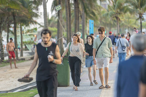 17 February 2026, Da Nang - Vietnam.Tourists stroll across the sandy shoreline, enjoying the open coastal setting. Walking along the beach is a common leisure activity in Da Nang, particularly during the early morning and late afternoon when temperatures are milder.