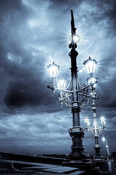 Retro lampposts and lights on The Liberty Bridge in Budapest at night.