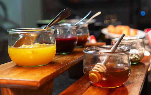 Glass jars with honey and fruit jams.