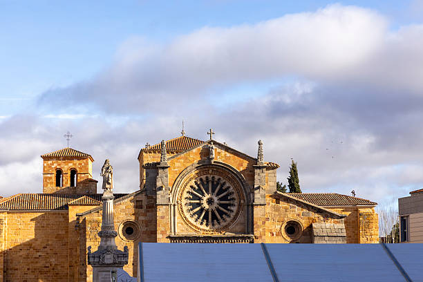A large church with a large stained glass window. The window is in the center of the building