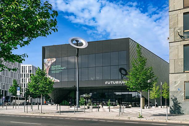Berlin, Germany – April 29, 2024: Futurium museum in Berlin showcasing modern architecture and a sleek glass façade, urban plaza with trees and contemporary street furniture, evoking innovation, science and future-focused design in Germany.