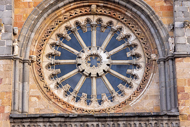 A large stained glass window with a blue circle in the center. The circle is surrounded by many small circles