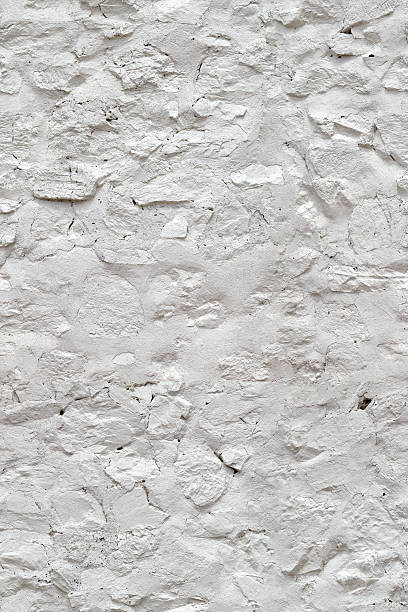 White painted stone wall seamless texture pattern. Traditional Spanish architecture details and materials.