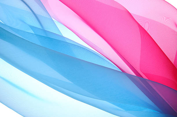 Blue and pink silk fabric moves gracefully in the air, creating a layered look. The light fabric appears to float, adding texture and depth to the scene.