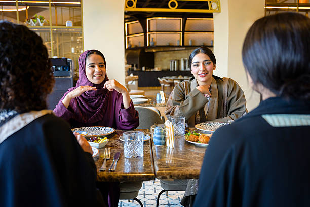 istock Group of people enjoying lunch and conversation in restaurant 2262321003