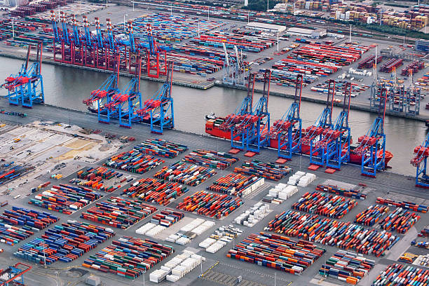 Busy container terminal in the Portof Hamburg, Germany. Container ships getting loaded and unloaded.