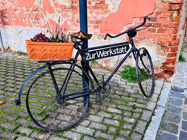 Close-up of a vintage bicycle handlebar against a white brick wall background.