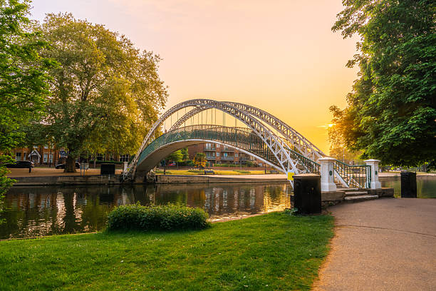 The white butterfly bridge arching over the river great ouse in bedford, england, during a beautiful sunrise