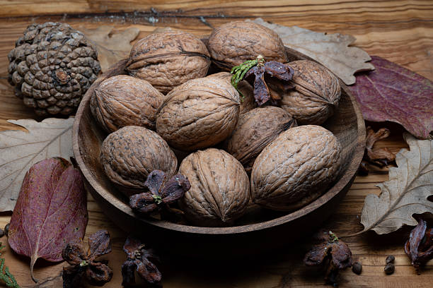 A composition of typically autumnal fruits such as walnuts, enhancing their beauty and detail