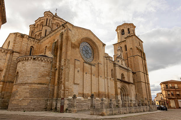 A large church with a large window and a steeple in Toro, Spain. The building is old and has a lot of detail