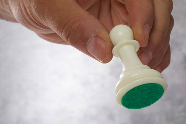 close - up of a man 's hand holding chess