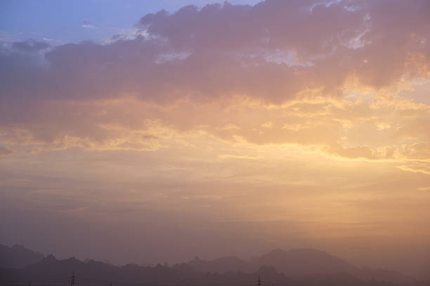 Sunset landscape with dark mountain peaks in egyptian desert.