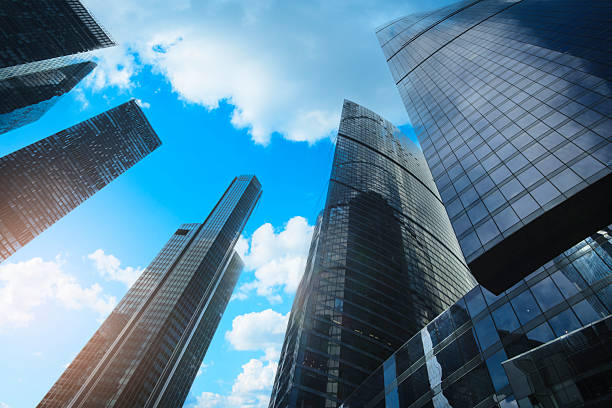 Tall office skyscrapers with sky reflection in windows, business concept banking background