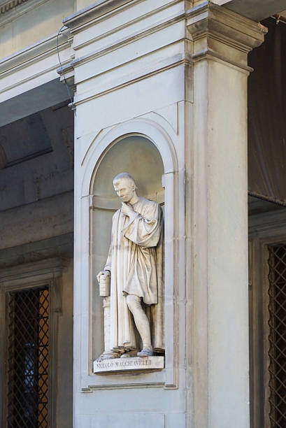 Niccolo Macchiavelli sculpture in the Piazza della Signoria. The statue is located in a niche in the colonnade of the Uffizi Gallery in Florence, Italy. It was created by the sculptor Luigi Pampalon.