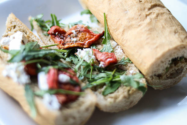 Savor a delicious open faced Veggie Sandwich with fresh arugula and sun dried tomatoes, perfect for a quick lunch or snack